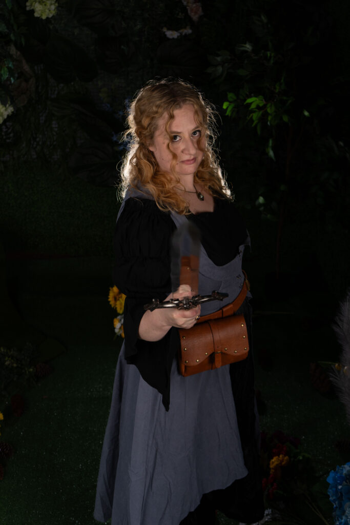 Jill25 woman pointing a sword toward the camera